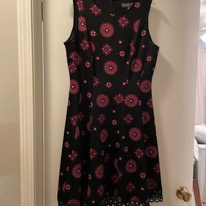 Sleeveless scuba fit and flare scuba dress with beautiful decorative hem.